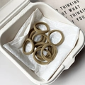 Pack of Earth-tone elastic hair ties in a minimalist cream box on white paper - Yellow