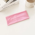 Minimalist elastic knitted sports headband in soft pastel pink color laid flat - Pink