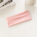Elastic pink sports headband for running and yoga fitness on a minimalist background - Lotus Pink