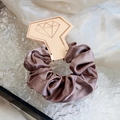Elegant tan satin scrunchie with glossy finish on gold-stamped diamond display card - Dusty Pink