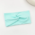 Mint green ribbed knit cross twist headband with elastic fabric for yoga and sports - Light Blue