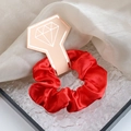 Red crystal satin scrunchie on a diamond-shaped card for elegant hair styling - Red