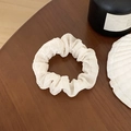 Chouchou élégant crème avec texture seersucker sur une table en bois foncé - Crème Seersucker Plissé (8#)