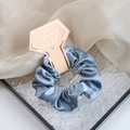 Elegant Morandi blue satin hair scrunchie on diamond-shaped card packaging - Grey Blue