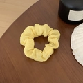 Chouchou en mousseline jaune pâle avec texture plissée sur table en bois foncé - Plissé Fin Jaune Clair (14#)