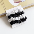 Set of 4 satin silk scrunchies in black and white colors on a white display card - Black and White Splicing