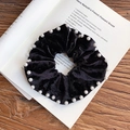 Chouchou élégant en velours noir orné de perles blanches sur fond de livre vintage usé - Noir (Style 1)