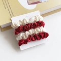 Set of four glossy satin scrunchies in cream and burgundy on a display card - Red and Beige Splicing