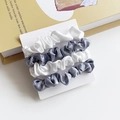 Set of 4 satin hair scrunchies in white and grey-blue on display card with prop book - Grey And White Block