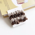 4-pack champagne and chocolate satin scrunchies set on display card over a prop book - Gray and Khaki Splicing
