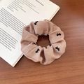 Brown flocking bow print scrunchie made of textured twill fabric for elegant hair styling - Khaki