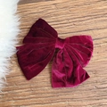 Handmade burgundy velvet bow hair clip with elegant golden-red sheen on wooden background - Burgundy