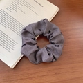 Grey elastic scrunchie with black bow prints on a high-quality textured fabric - Gray