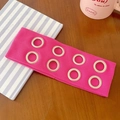 Pink ribbed punk headband with silver metal grommets on a stylish wooden background - Rose Pink