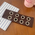 Dark brown ribbed knit headband with silver metal eyelets on a wooden table surface - Dark Brown