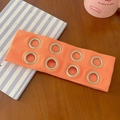 Orange ribbed knit headband featuring eight silver metal eyelets in a punk rock style - Orange