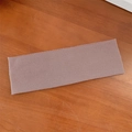 Dusty rose ribbed knit elastic headband for yoga and sports on a wooden surface - Camel
