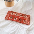 Red paisley bandana headband featuring metallic grommet eyelets and a vintage pattern - Paisley Orange