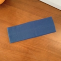 Navy blue elastic knitted yoga headband with ribbed texture on a wooden background - Blue Gray