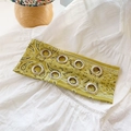 Green paisley printed headband with silver metal grommets on a soft fabric surface - Paisley Yellow Green