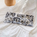 White headband with black splash print and silver metal grommets on textured fabric - Ink White