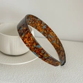 Macro detail of blue marble textured wide headband with glossy acetate finish - Lake Blue Brown