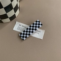 Detail view of a rectangular black and white checkered hair clip on leather background - Black & White Checkerboard Rectangular
