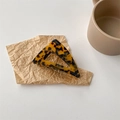 Macro shot of a triangular tortoiseshell acetate hair claw clip on vintage kraft paper background - Dark Tortoiseshell