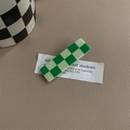 Close-up of green and cream checkerboard barrette on vintage leather background - Green & Beige Checkerboard Rectangular