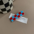 Detail of a red and blue checkered acrylic hair clip on a beige textured leather background - Red & Blue Checkerboard Rectangular