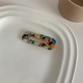 Detail view of a French vintage acetate hair clip with a colorful terrazzo marble pattern - Tortoiseshell Marble Square