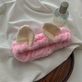 Detailed macro shot of soft pink coral fleece animal ear headband for skincare routines - Pink Cat Ear