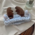 Close-up of soft blue plush headband with brown reindeer antlers for face washing - Light Blue Antlers