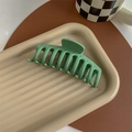 Detail of large matte green shark hair claw clip on aesthetic beige tray setting - Matte Fruit Green