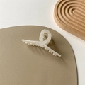 Detail view of pearlescent white marble acetate hair claw clip on soft textured surface - Mermaid Color
