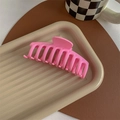 Close-up of pink matte hair claw clip on a decorative tray for elegant hairstyling - Matte Peach Pink