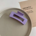 Detail of large square purple hair claw clip with matte finish on a ceramic plate - Matte Purple
