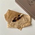 Nahaufnahme der Haarspange aus Acetat mit Schildpatt-Muster auf Vintage-Papier - Dunkler Schildpatt Stil