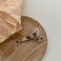 Close-up of a creative scissors-shaped hair clip with vintage tortoiseshell resin texture - Tortoise