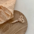 Close-up of beige marble pattern resin scissor hair clip on a natural wooden tray - Beige Series
