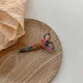 Detailed close-up of a scissor-shaped resin hair clip with vibrant marble textures - Multicolor Series