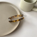 Dettaglio del fermaglio a banana tartarugato con denti interni e chiusura di sicurezza - Tartarugato Leopardato Scuro / Stampa Leopardata Scura