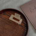 Dettaglio macro di una pinza per capelli vintage in acetato con finitura perlata su legno - Rettangolare Medio