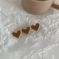 Close-up of triple heart-shaped hair clip with brown finish on white textured paper - Heart-Coffee