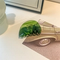 Macro shot of dark green translucent claw clip with a glossy finish and non-slip design - Large Semicircle