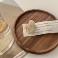 Macro detail of mini acetate hair claw clip with creamy marble pattern on a wooden tray - Mixed Beige