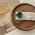 Close-up of a green marble pattern mini hair claw clip on a dark wooden vintage tray - Emerald Glaze