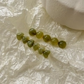 Detailed view of two green hair clips with marbled resin round and heart-shaped beads - Jelly Green