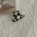 Close-up of black and white checkered acetate hair claw with golden La France logo detail - Black and White Checkerboard (PVC)
