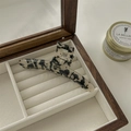 Detailed macro view of acetate hair claw with marble texture and silver metal spring - Black